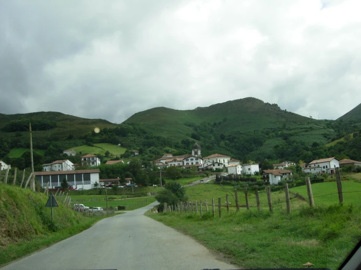 a small country road on a green hill side