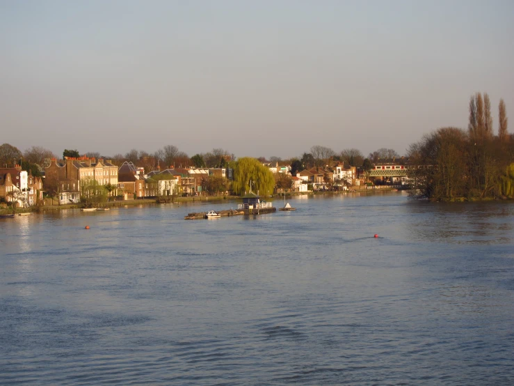 boats sitting in the water in front of some houses