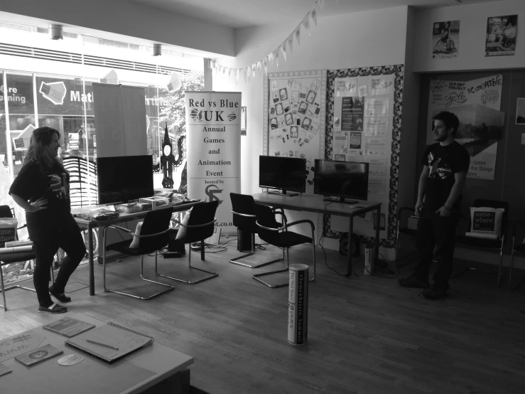 a person stands in an open room with several computers