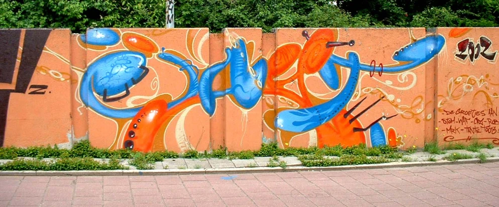 a fence that has been grafitti with a blue bird painted on it