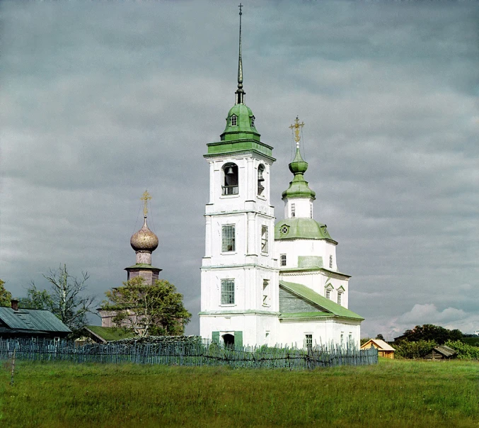 a church with a steeple surrounded by trees