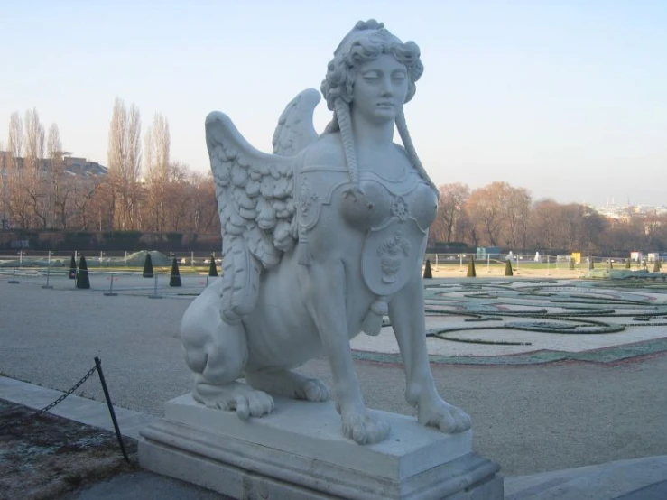 a statue in a park with many circular mirrors