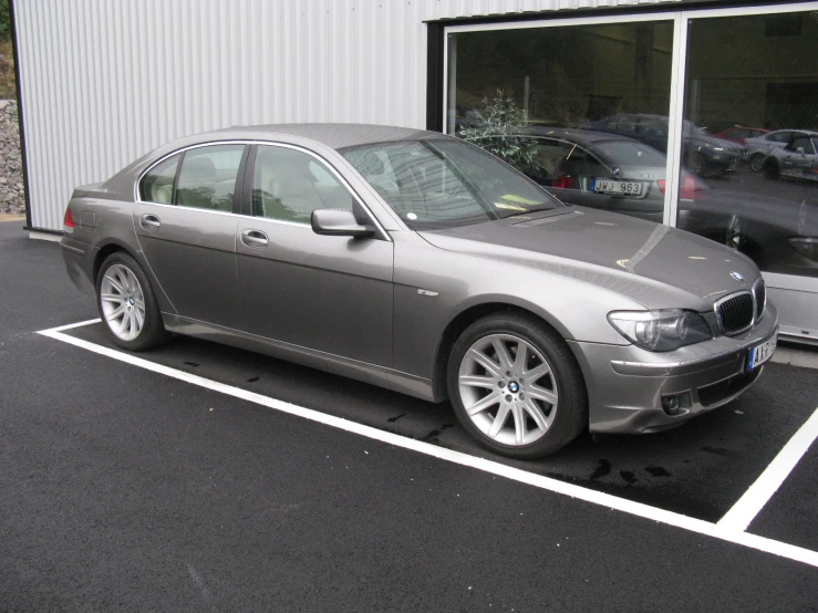 a silver car sitting in the middle of a parking lot