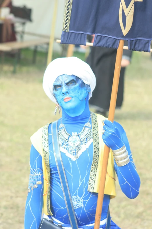 the woman is dressed in blue with makeup