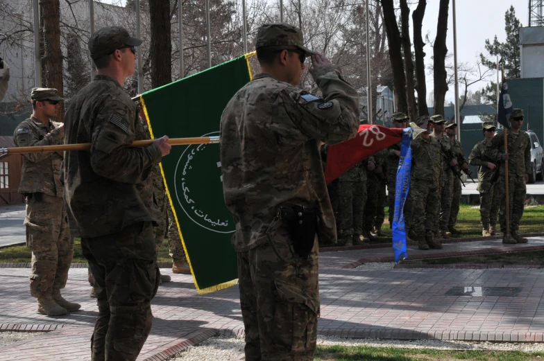 soldiers are holding flags while standing near each other