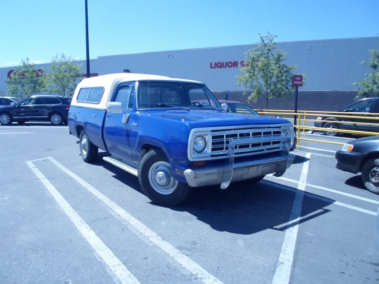 a blue truck parked in a parking lot