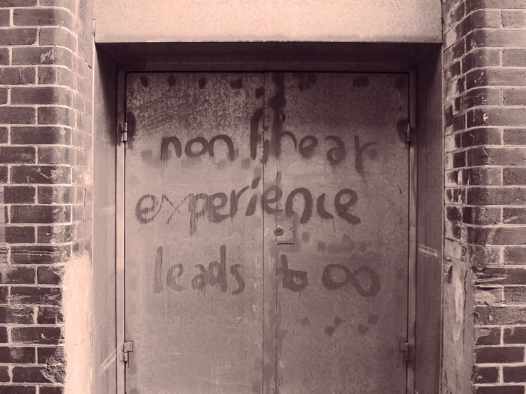 some graffiti written on the outside of a door