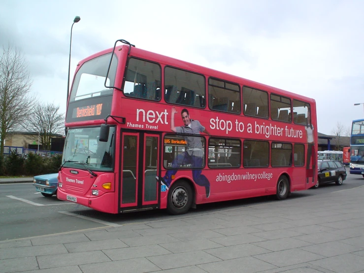 a double decker bus stopped on the side of the road