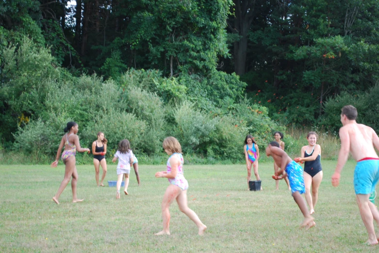 many people in bathing suits playing with an outside game