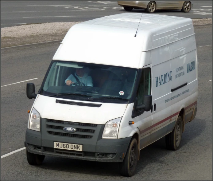 a man sitting in his van going down the road