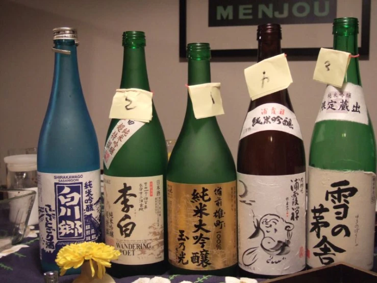 five sake bottles containing four different types of sake