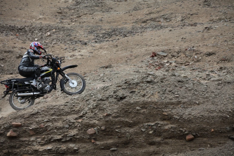 a person riding on the back of a dirt bike