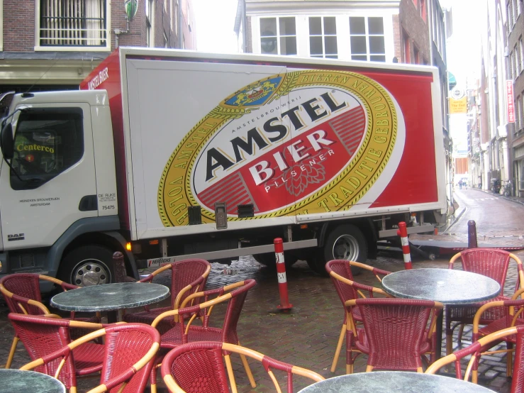 a large box truck parked in front of many tables