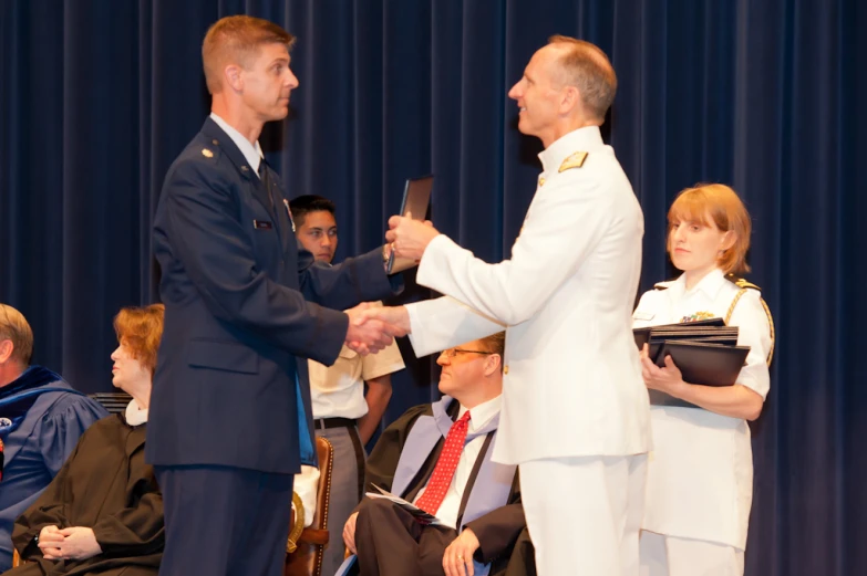 a man in a uniform is receiving his medal