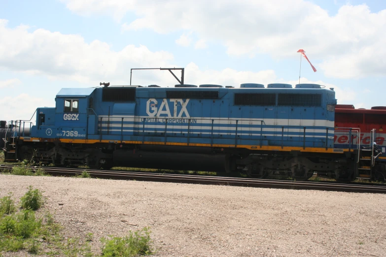 a train engine sitting on the tracks in a rail yard