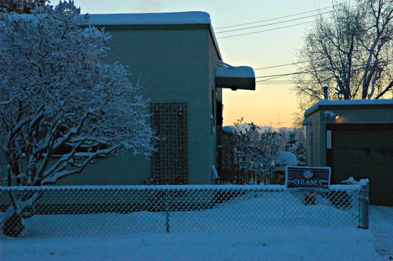 a view of houses and street lights in the snow