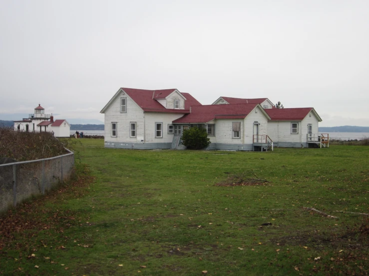 a house on a field next to a light house