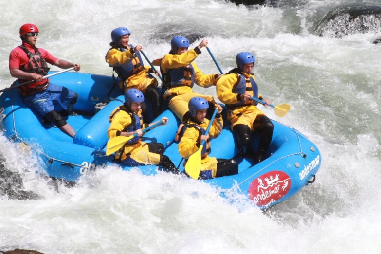 a group of people in a raft on some rough waves