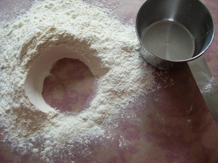 there is sugar in the bowl next to the measuring spoon