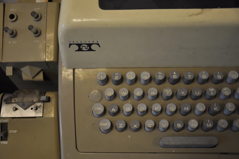 an old typewriter sits on display near other old typewriters