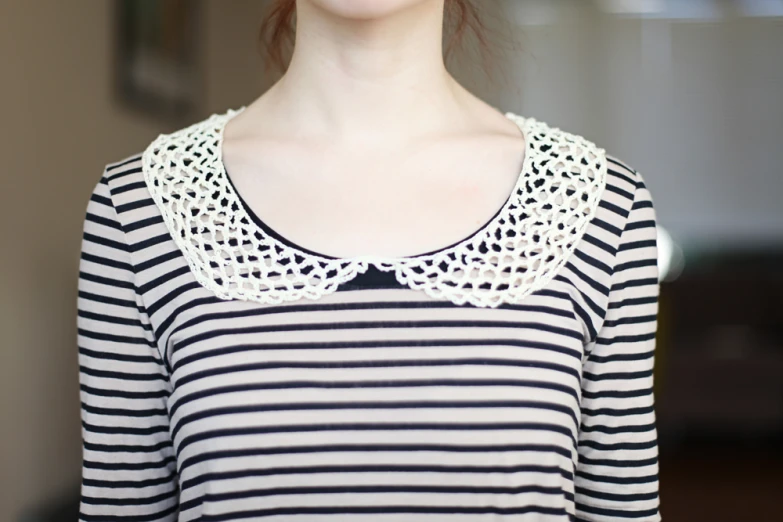 woman's white and black top with lacy lace neck