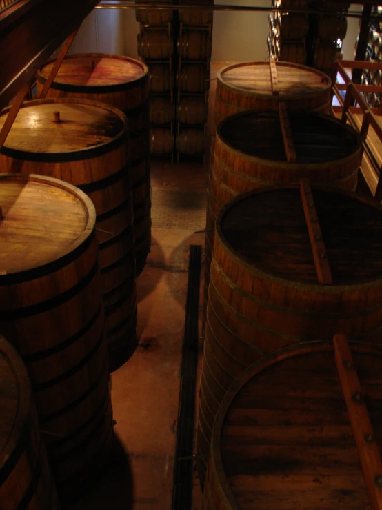 a large collection of barrels in a dark room