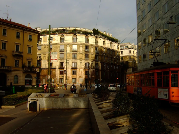 a large brick building is next to a red trolley