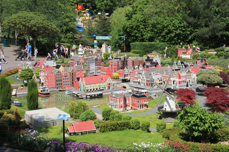 people walking and riding bikes near miniature buildings