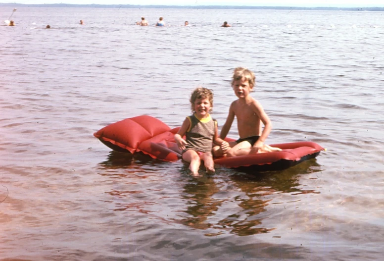 two little boys playing in a body of water