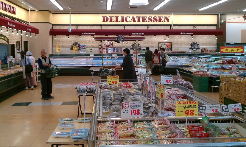 people standing around in the aisles of a grocery store