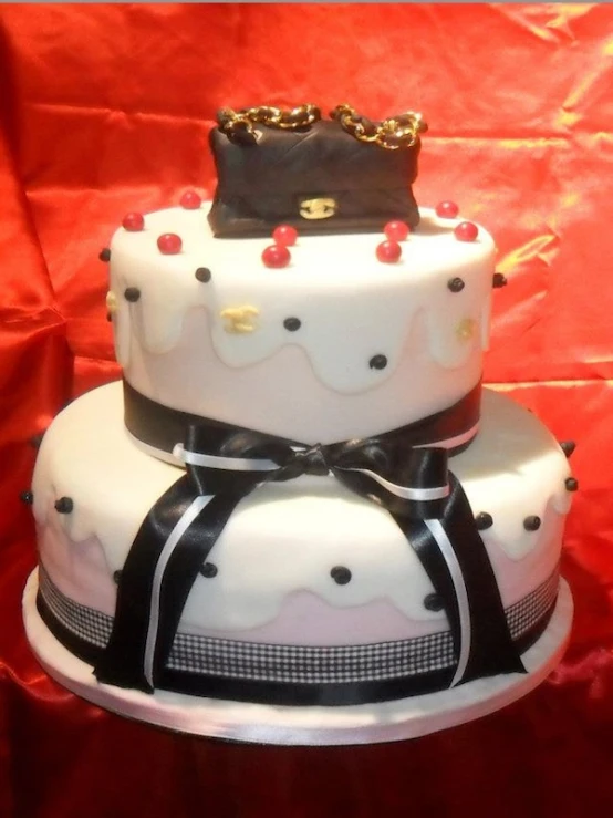three tiered wedding cake with white and black icing with polka dots