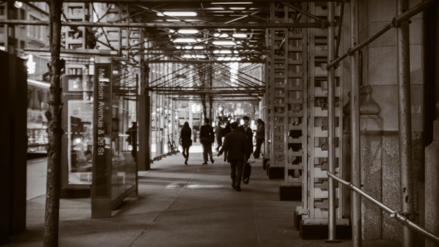 black and white pograph of people walking on a street