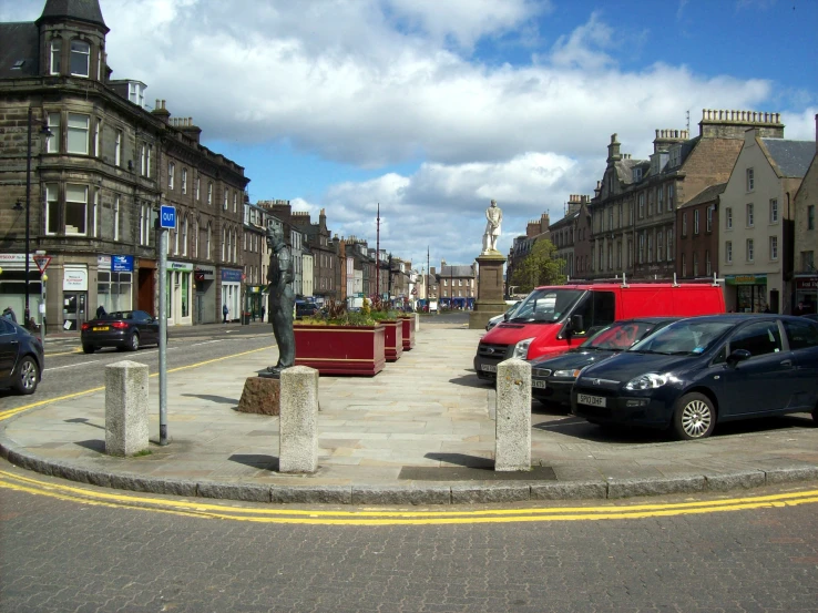 cars parked on the street in front of brick buildings