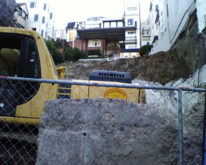 construction equipment is in front of an unfinished building