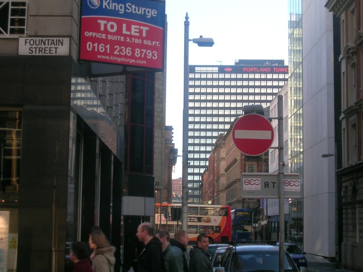 a busy street with tall buildings on both sides