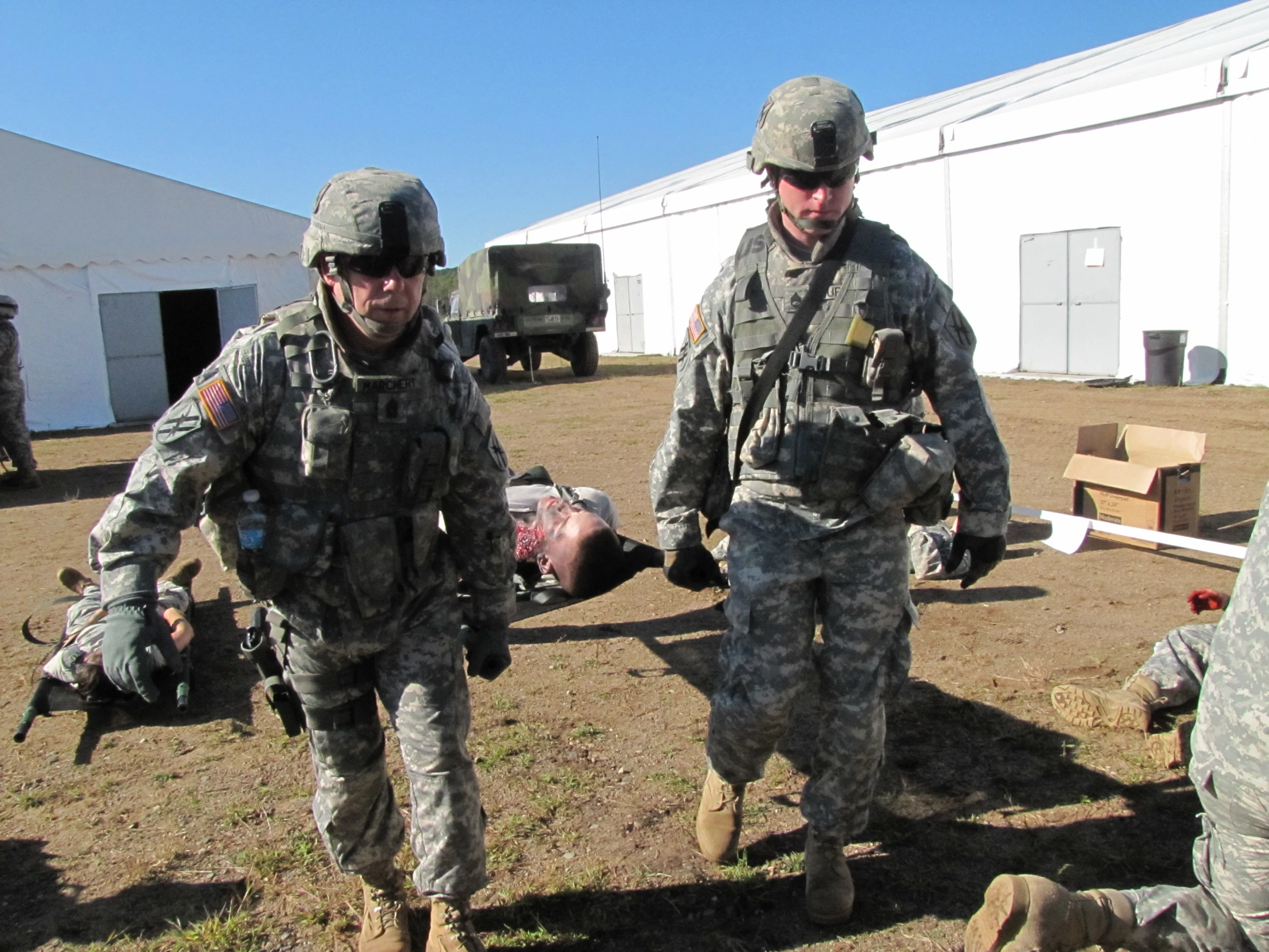 the men are dressed in army fatigues and carrying soing