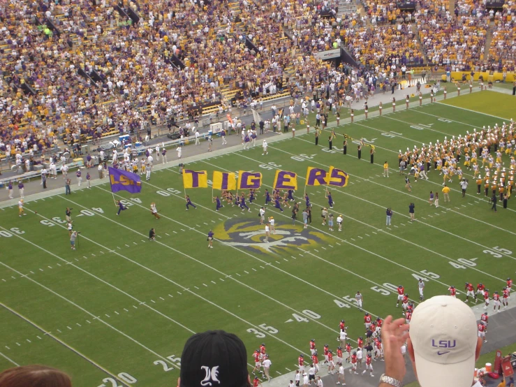 a group of people standing on top of a football field