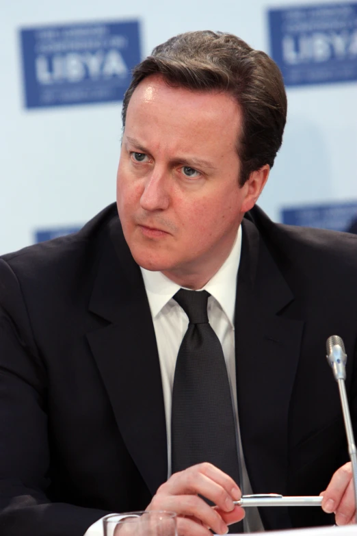 the man sitting in front of a microphone