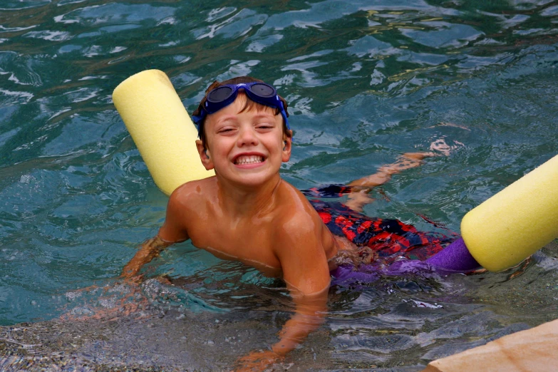 a person is swimming with a tube and a swim vest