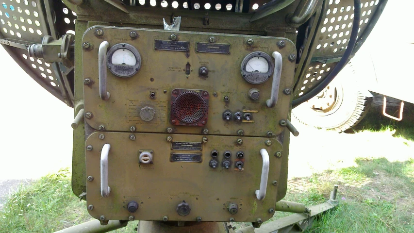 an odd metal piece sitting in the middle of a field