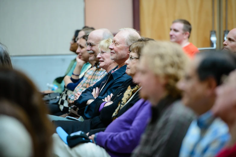 a large group of people sitting together in a room