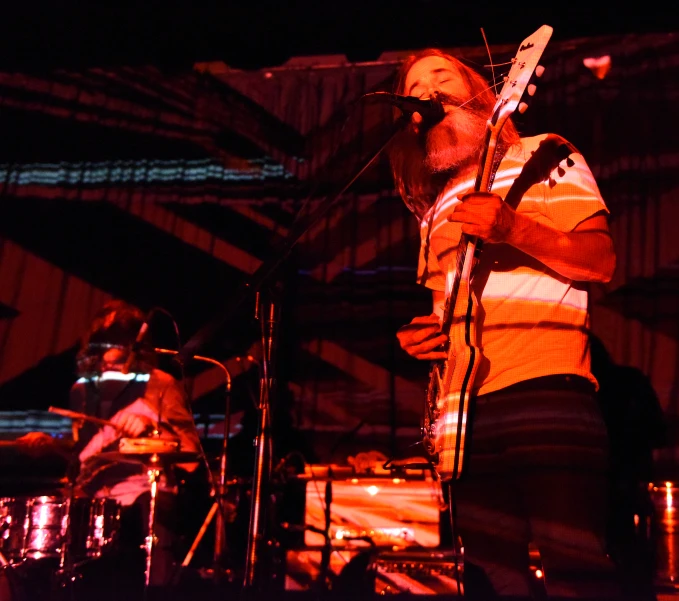 a man with a guitar in his hands at night