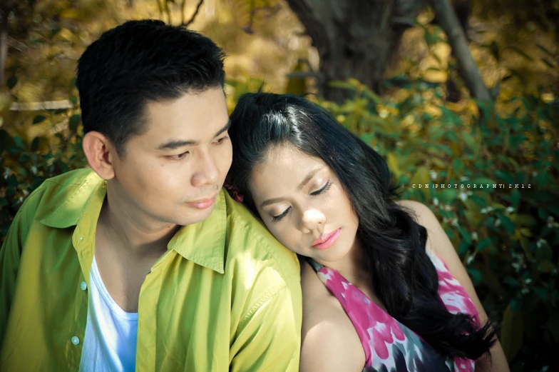 a young man and woman look at the camera