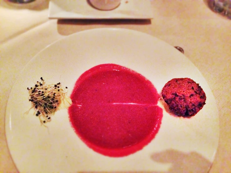 a plate with red food is on top of a counter