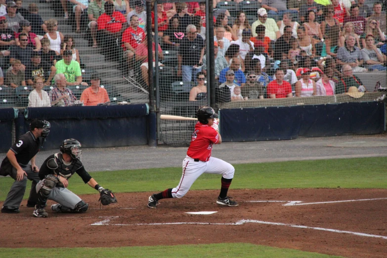 a baseball player taking a swing at a ball