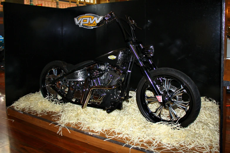 a motorcycle on display on a wooden shelf