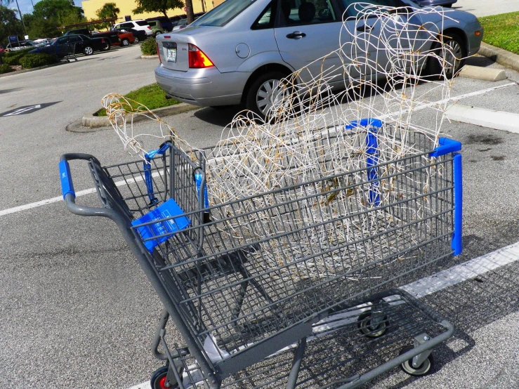 a grocery cart that has fallen over and is parked in a parking lot