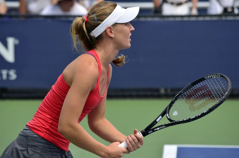 a woman getting ready to play tennis on the court