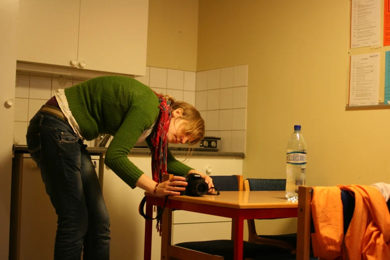 a woman at a table with her camera