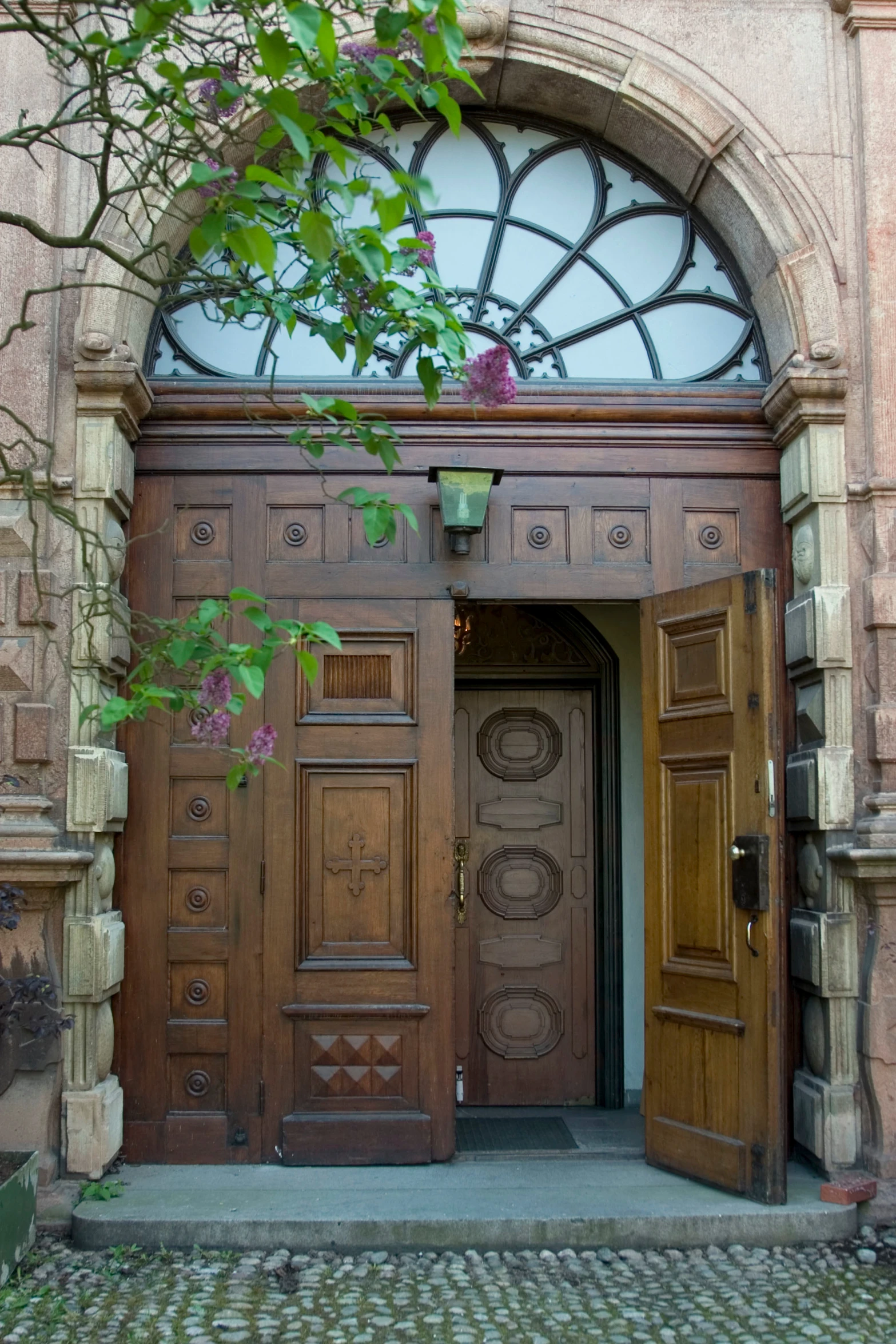 a doorway with two open and closed wooden doors